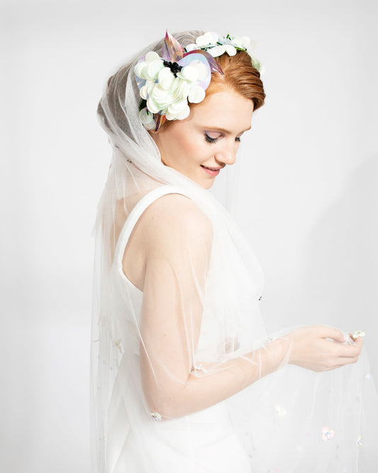 Bride wearing veil with sequin flower crown hair accessory