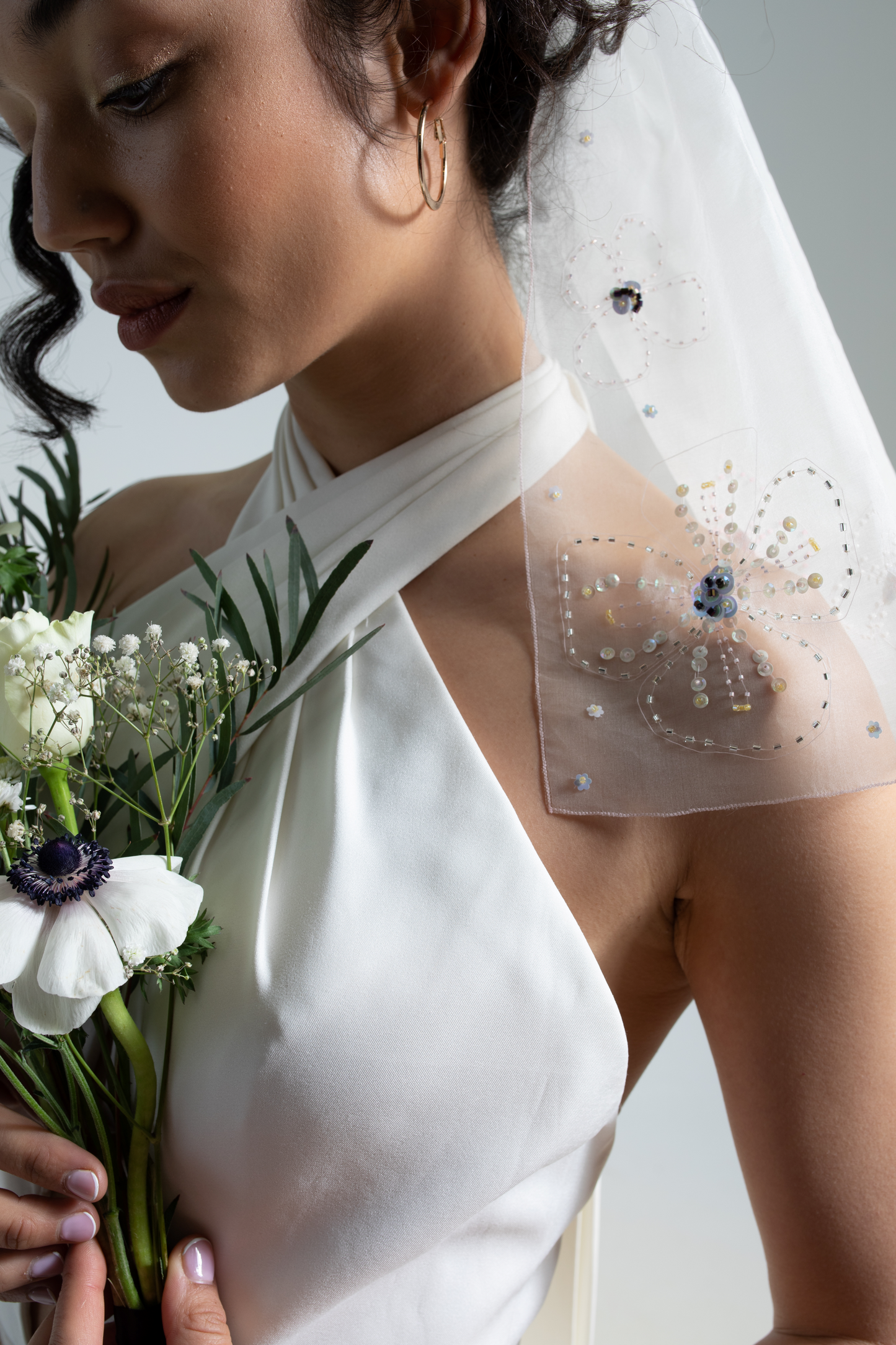 Hand embroidered wedding veil; subtly coloured sequins and beads hand-sewn onto a short silk organza bridal veil. This floral embroidered wedding veil is part of a collection of luxury bridal accessories and bridal headwear.