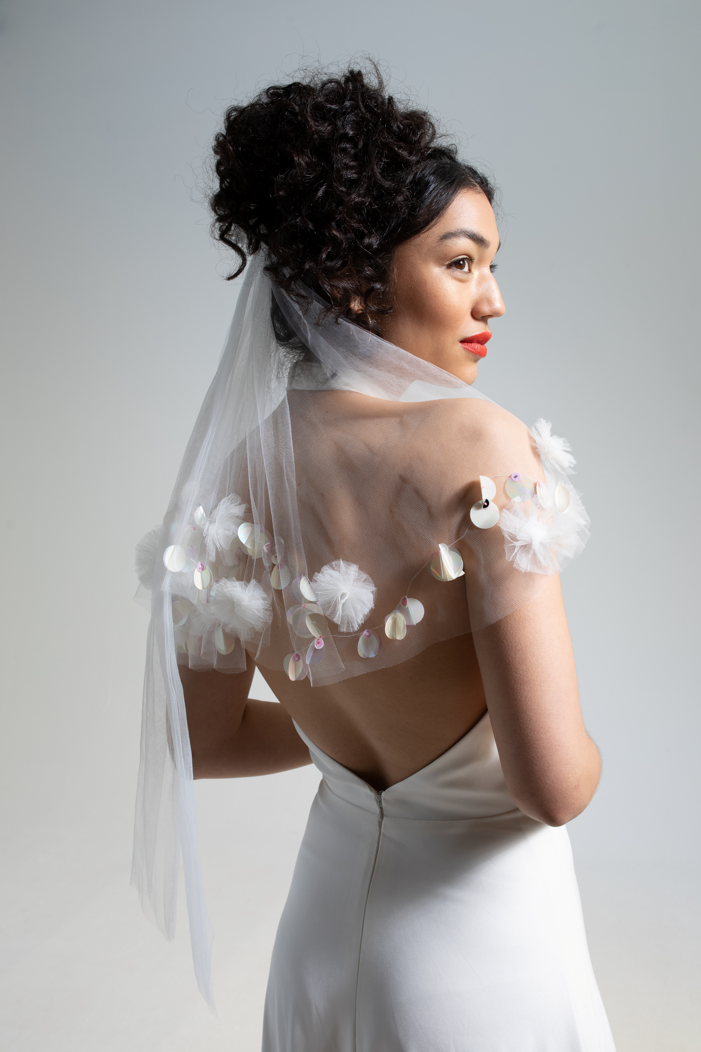 hand embroidered tulle wedding veil embellished with hand sewn sequins and tulle pom poms, an embroidered wedding veil as part of a collection of decorative luxury bridal accessories and bridal headwear and veils