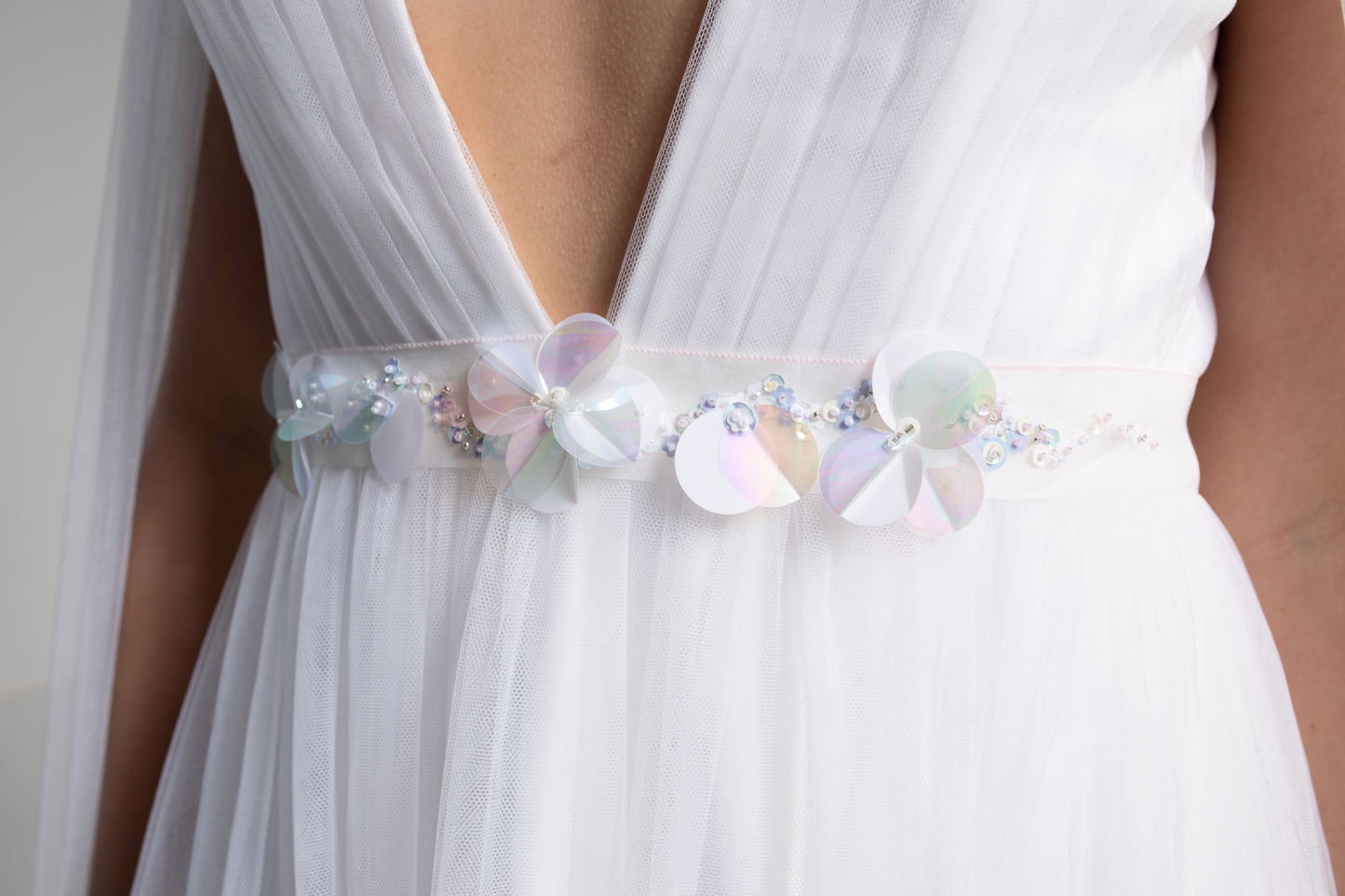 Hand embroidered silk organza bridal sash, a decorative sash hand-sewn with lots of sequins and beads in a floral design. This bridal belt is part of a collection of luxury hand-embroidered bridal accessories and bridal head wear.