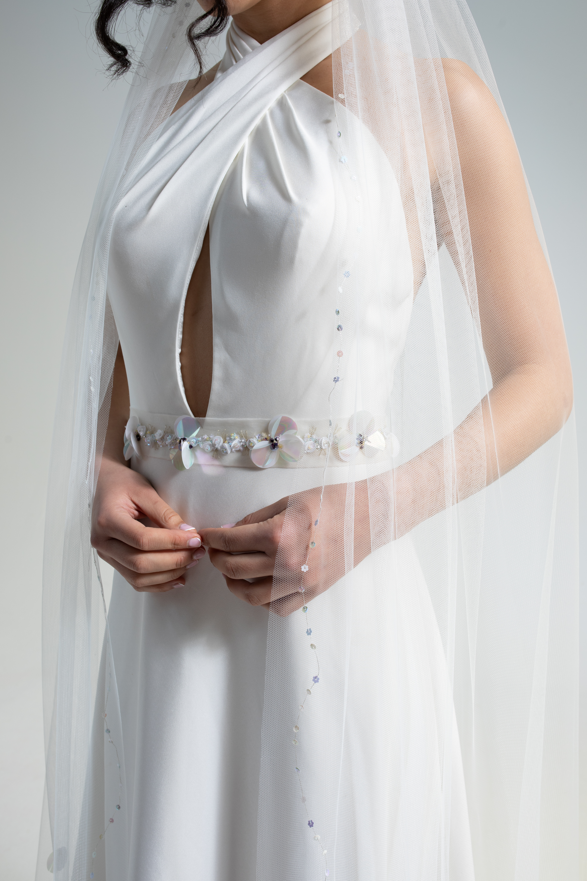 Hand-embroidered silk organza wedding belt decorated with hand-sewn sequins and beads in a floral design. This embellished bridal belt is part of a collection of luxury hand-made bridal accessories.