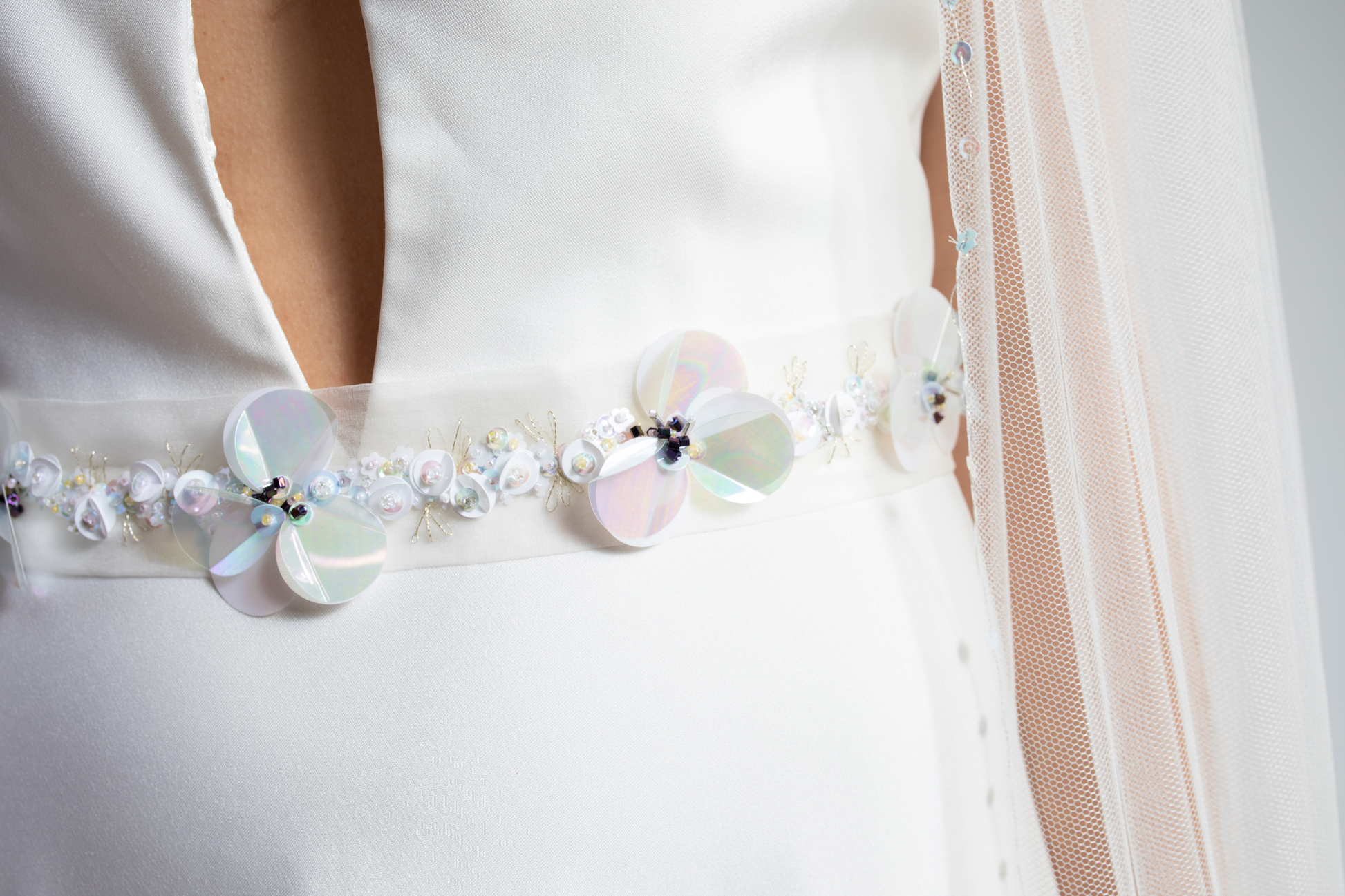Hand-embroidered silk organza wedding belt decorated with hand-sewn sequins and beads in a floral design.  This embellished bridal belt is part of a collection of luxury hand-made bridal accessories.